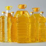 Bottles of cooking oil on light background Bottles of cooking oil on light background