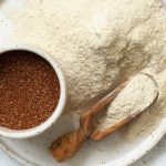 Teff flour on a plate and teff grain with a spoon top view Teff flour on a plate and teff grain with a spoon top view